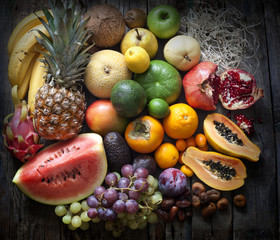 Exotic fruits variety still life on vintage wooden boards