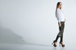 © julenochek - Fashionable woman with a bag in light background