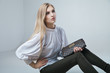 © julenochek - Fashionable woman with a bag in light background