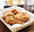fried chicken pile in a basket on table