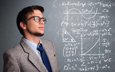 Handsome school boy thinking about complex mathematical signs