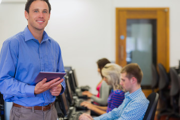 Canvas Print - Teacher with students using computers in computer room