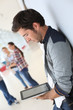 © goodluz - Young man in college campus connected on tablet