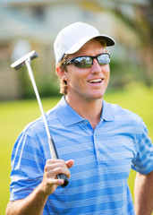 Wall Mural - Athletic young man playing golf