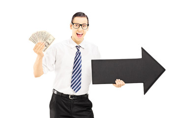 Wall Mural - Young businessman holding an arrow and dollars