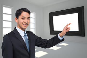 Poster - Composite image of smiling asian businessman pointing