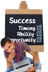 Fototapete - Composite image of thoughtful man sitting on floor using laptop