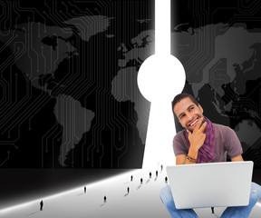 Poster - Composite image of thinking man sitting on floor using laptop an