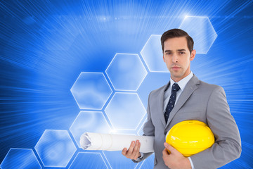 Wall Mural - Composite image of serious architect holding plans and hard hat