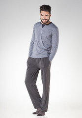 attractive men in pyjamas smiling isolated on grey - studio