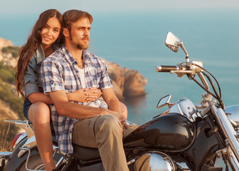 Wall Mural - fashion couple sitting on a motorcycle