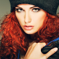 Beautiful redheaded girl in a sportwear, is in fashion style