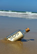 Distress message in a bottle on the deserted beach
