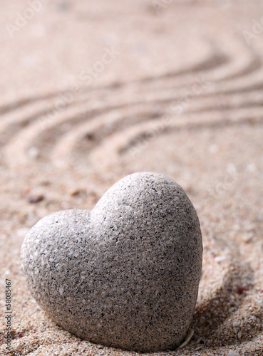 Fototeppich - Grey zen stone in shape of heart, on sand background (von Africa Studio)