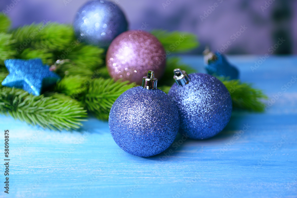 Christmas balls on fir tree, on color background