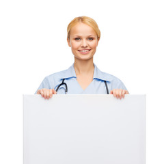 Poster - smiling female doctor or nurse with blank board