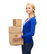 © Syda Productions - smiling woman in casual clothes with parcel boxes