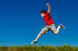 © Jacek Chabraszewski - Boy jumping, running against blue sky