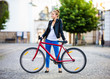 © Jacek Chabraszewski - Urban biking - young woman and bike in city