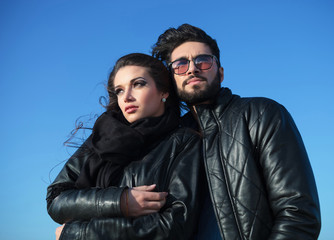 Canvas Print - pensive young couple standing against blue sky