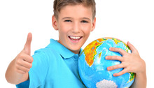 Smiling Boy In Casual  Holding Globe With Thumbs Up