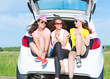 © adam121 - young attractive woman sitting in the open trunk