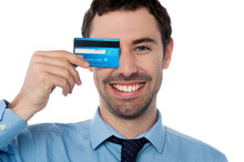 Businessman Hiding His Eye With Credit Card