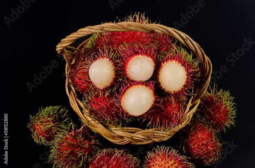 Rambutan in basket on a black background Canvas