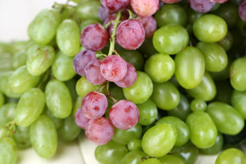  Ripe green and purple grapes close-up background