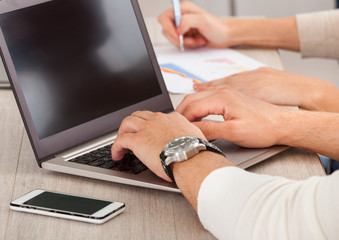 Businessman's Hand Working With Laptop In The Office