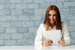 © Drobot Dean - Laughing young businesswoman looking at camera