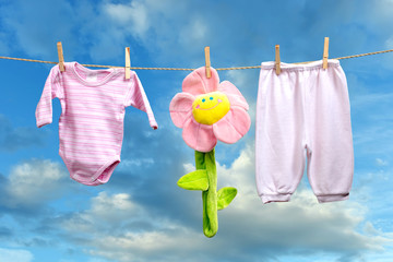 Baby girl clothes with flower  on the clothesline