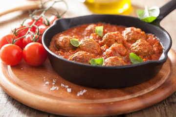 Wall Mural - meatballs with tomato sauce in black pan