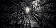 Abstract Black And White Wooden Bridge With Light Silhouette Of Man 