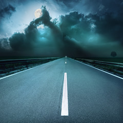 Canvas Print - Driving on asphalt road towards  oncoming stormy night