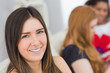 © WavebreakMediaMicro - Portrait of a brunette with female friends in background