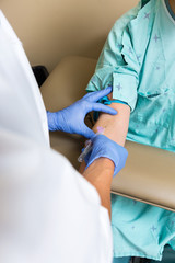 Wall Mural - Male Doctor Drawing Blood From Patient's Arm