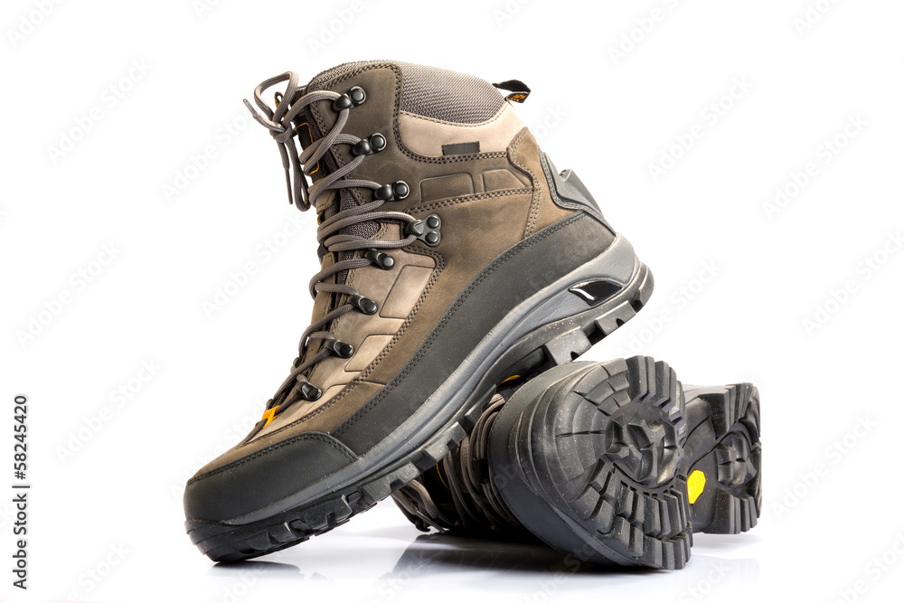 A pair of new hiking boots on white background - obrazy, fototapety, plakaty 