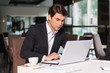 © BlueSkyImages - Handsome businessman working with laptop.