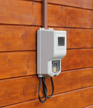 Electricity Supply Meter On Wooden Wall