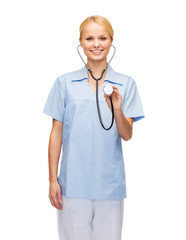 Poster - smiling female doctor or nurse with stethoscope