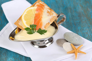 Sticker - Salmon sandwich with sauce on wooden table close-up