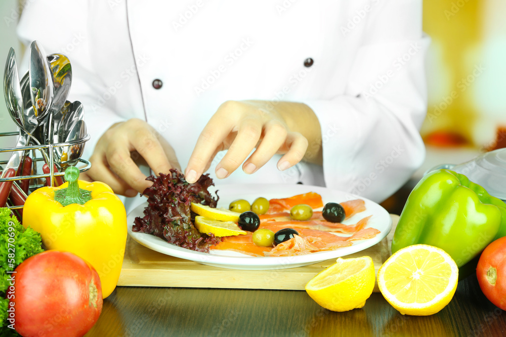 Cook hands decorating dish