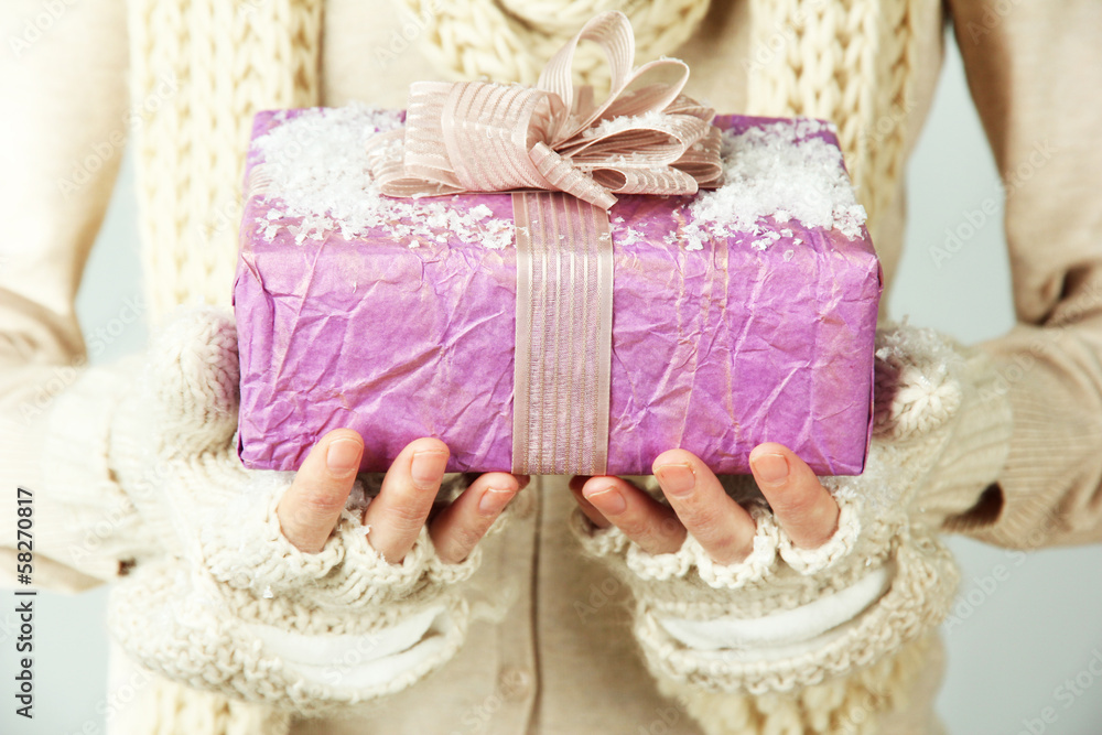 Female hands with gift box, close-up