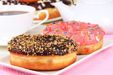 Wall Mural - Sweet donuts with cup of tea on table close-up
