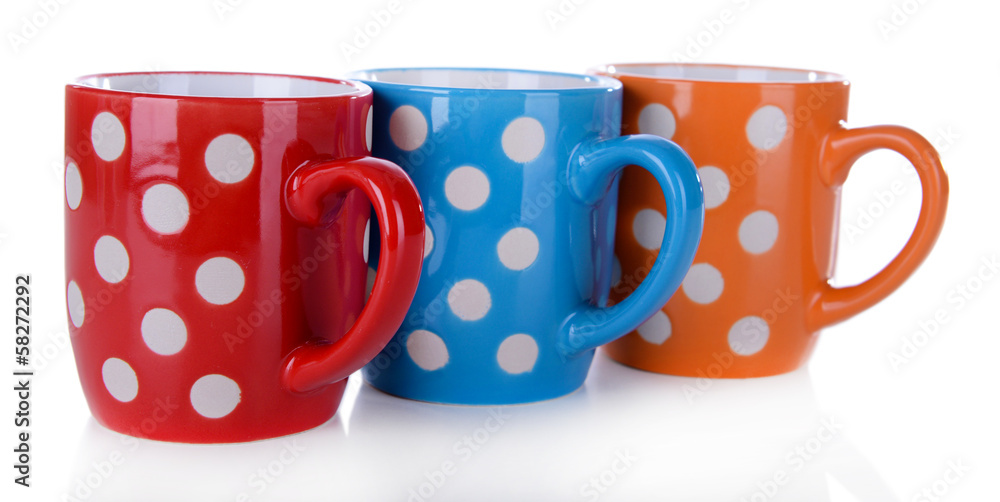 Color polka dot mugs isolated on white
