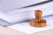 © Africa Studio - Wooden stamp and papers on table