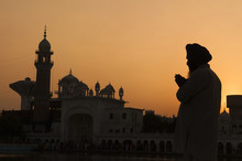 Silhouette Of Praying Sikh Man At Golden Temple Of Amritsar, Ind