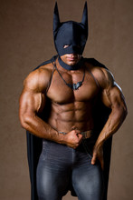 A Muscular Man In A Batman Costume.