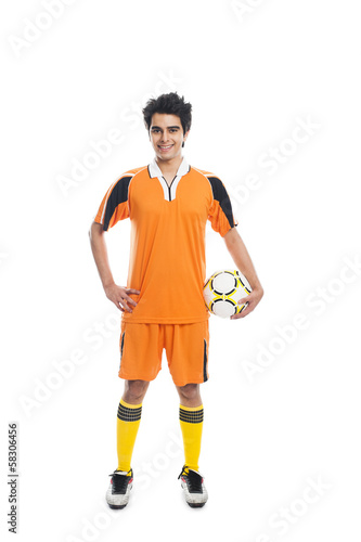 Fotografie, Obraz Portrait of a soccer player holding a soccer ball and smiling